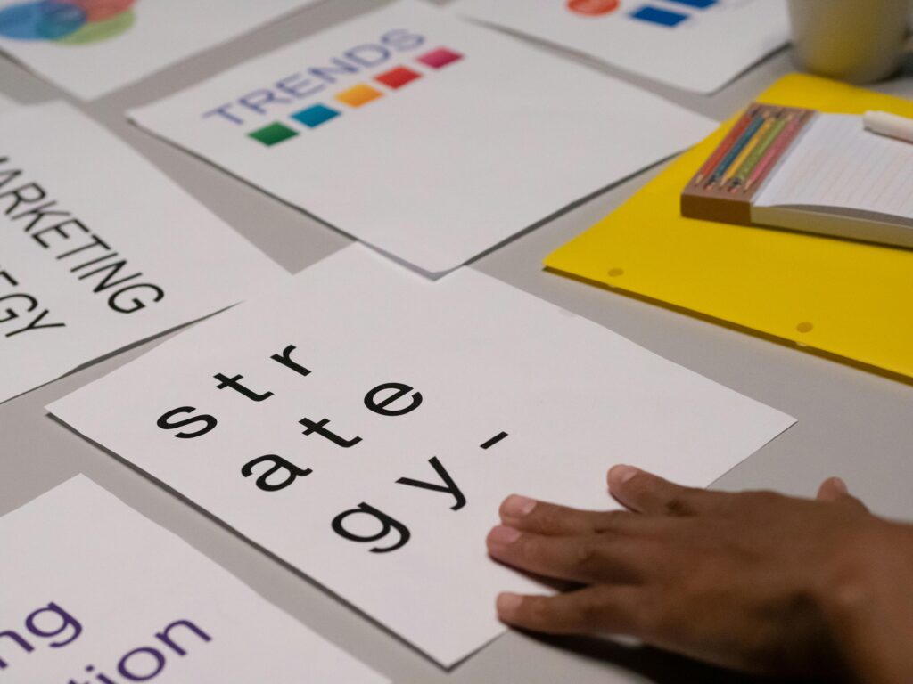 Close-up of marketing strategy notes and colorful trends sheet on a table for planning session.